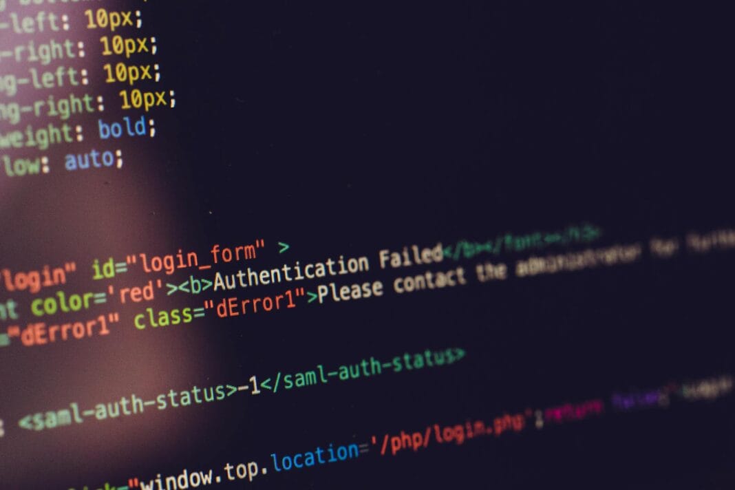 Ekran komputera z kodem HTML i komunikatem błędu uwierzytelniania